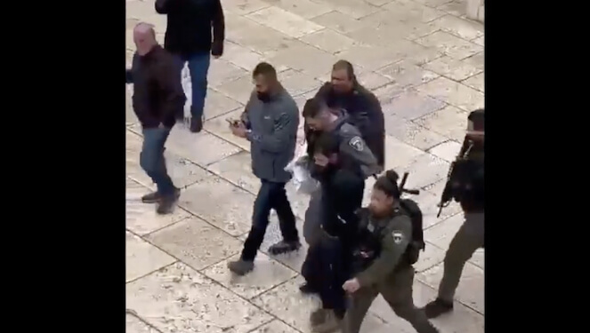 Screenshot image of assailant being led away from Jerusalems Church of Gethsemane.