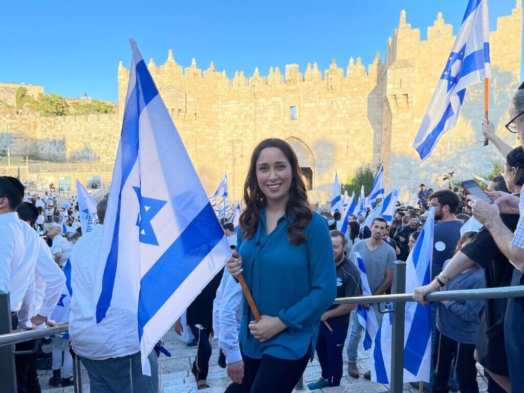 Knesset Member May Golan holding an Israeli flag at a settler 