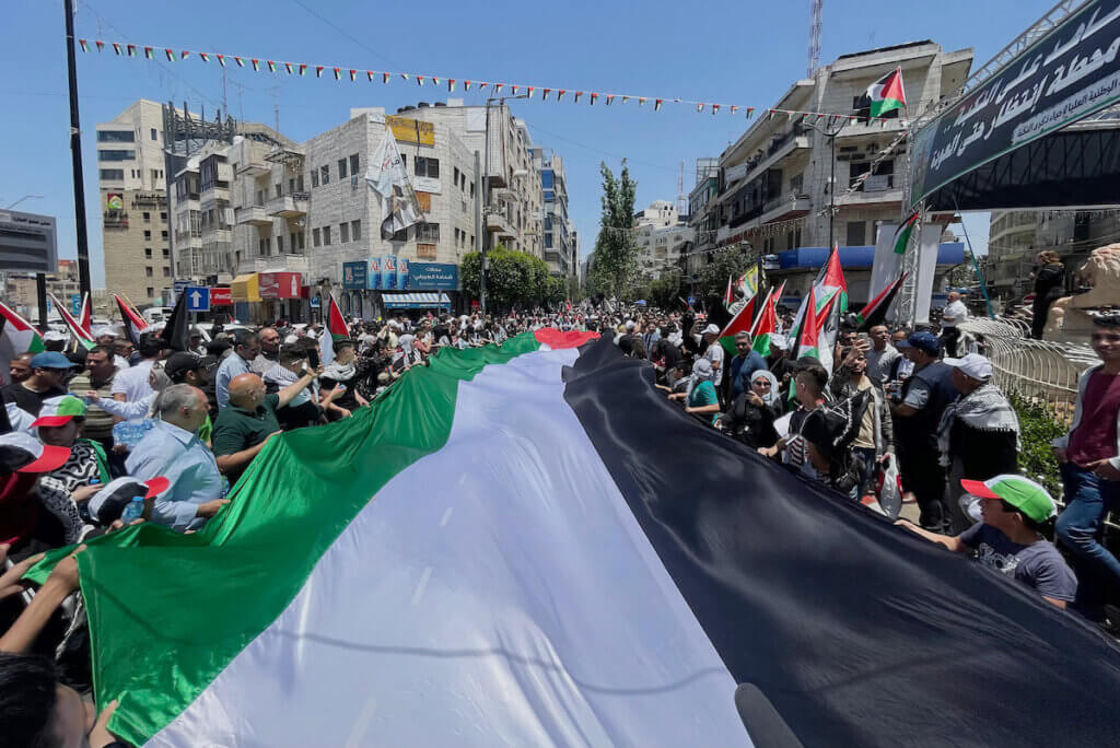 Palestinians take part in a march to mark the 75th anniversary of Nakba, or the 