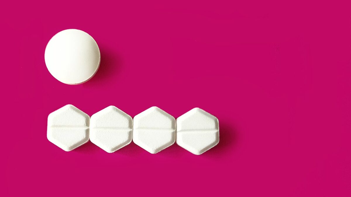 abortion pill on pink background