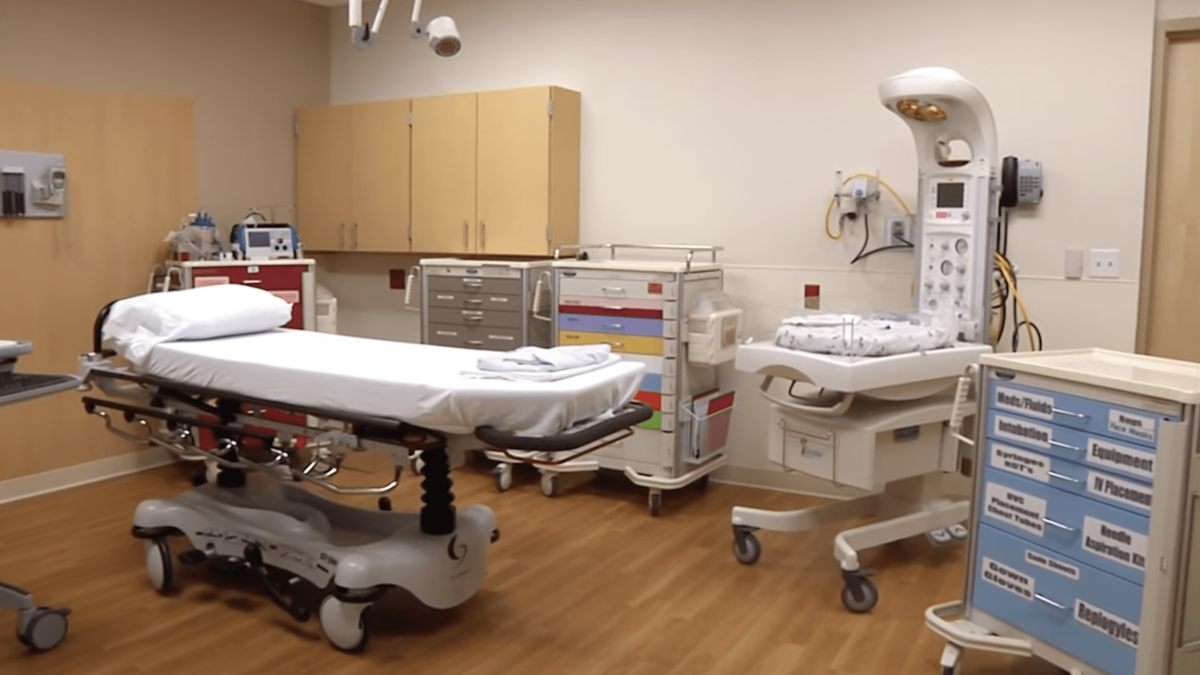 hospital triage room with bed and baby bed