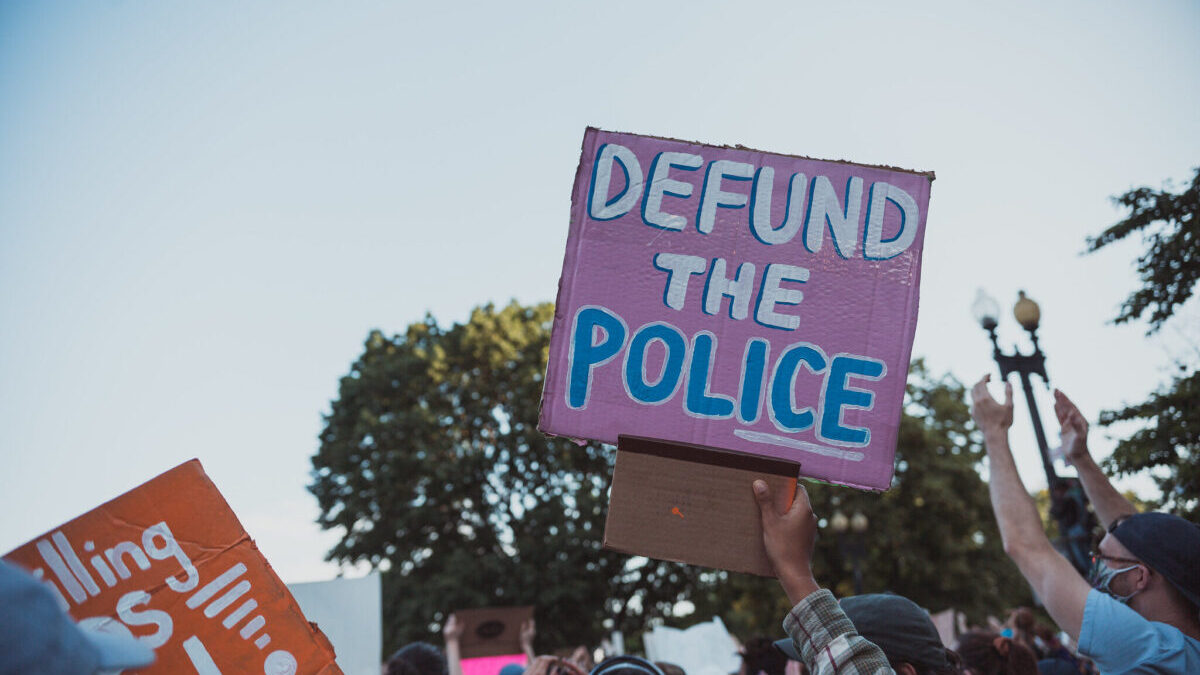 defund the police protest sign