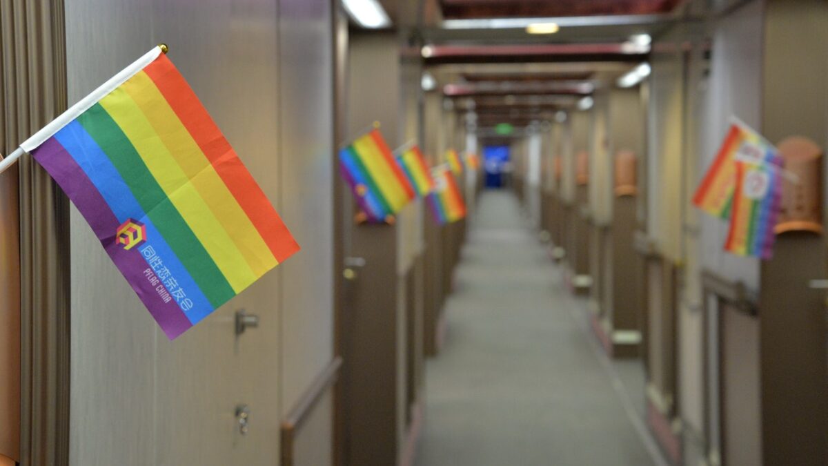 rainbow pride flags sticking out of lockers down hallway