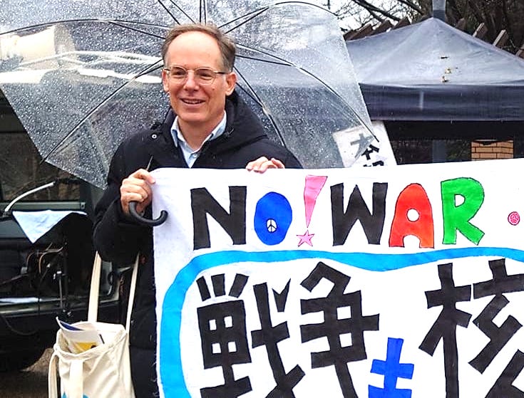 Joseph Essertier, professor at Nagoya Institute of Technology and coordinator of World BEYOND War Japan, holding up a 